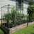 Outdoor Raised Garden Bed With A Protective Metal Fence Attached To A Pipe Frame